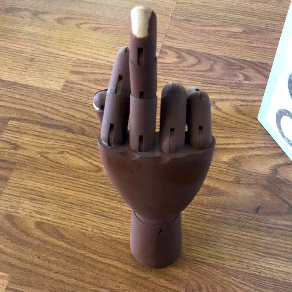 Art piece of a brown hand the fingers are adjustable nice statement piece